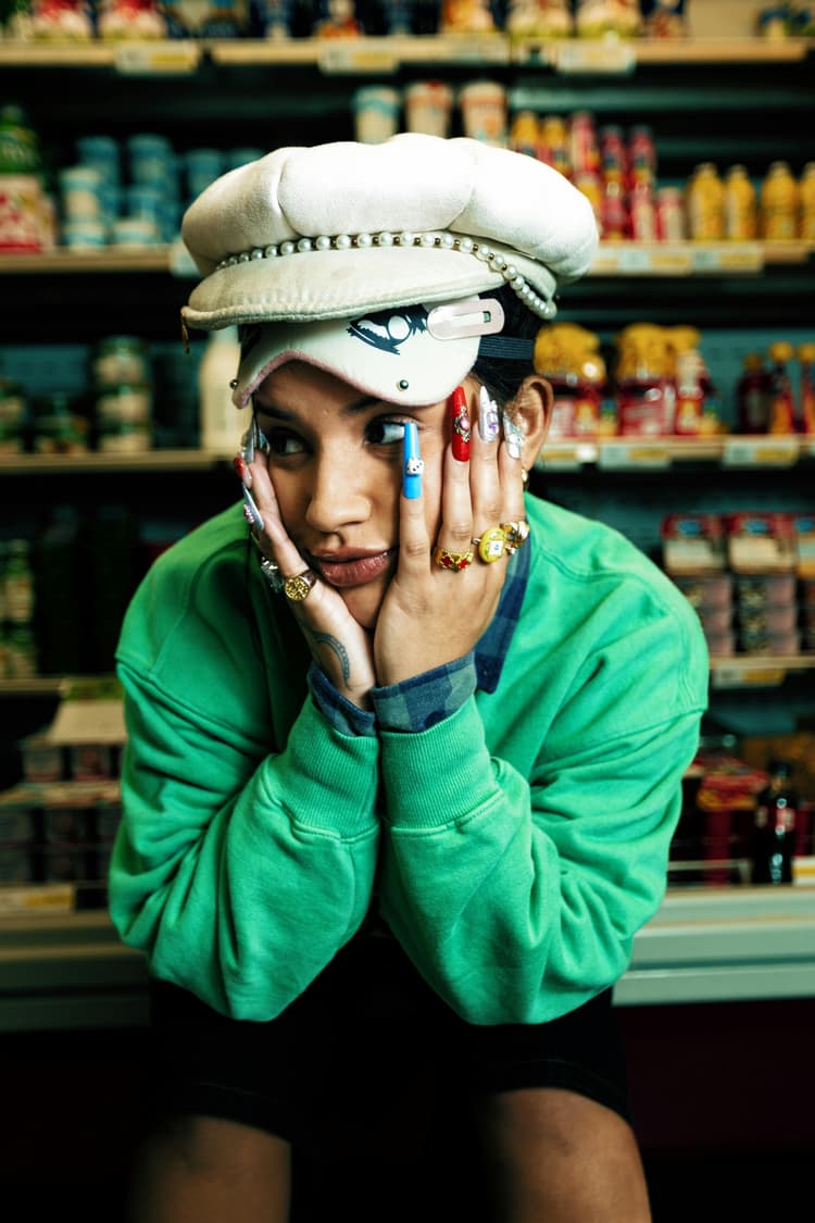 lady with a hat on with her hands on her face 