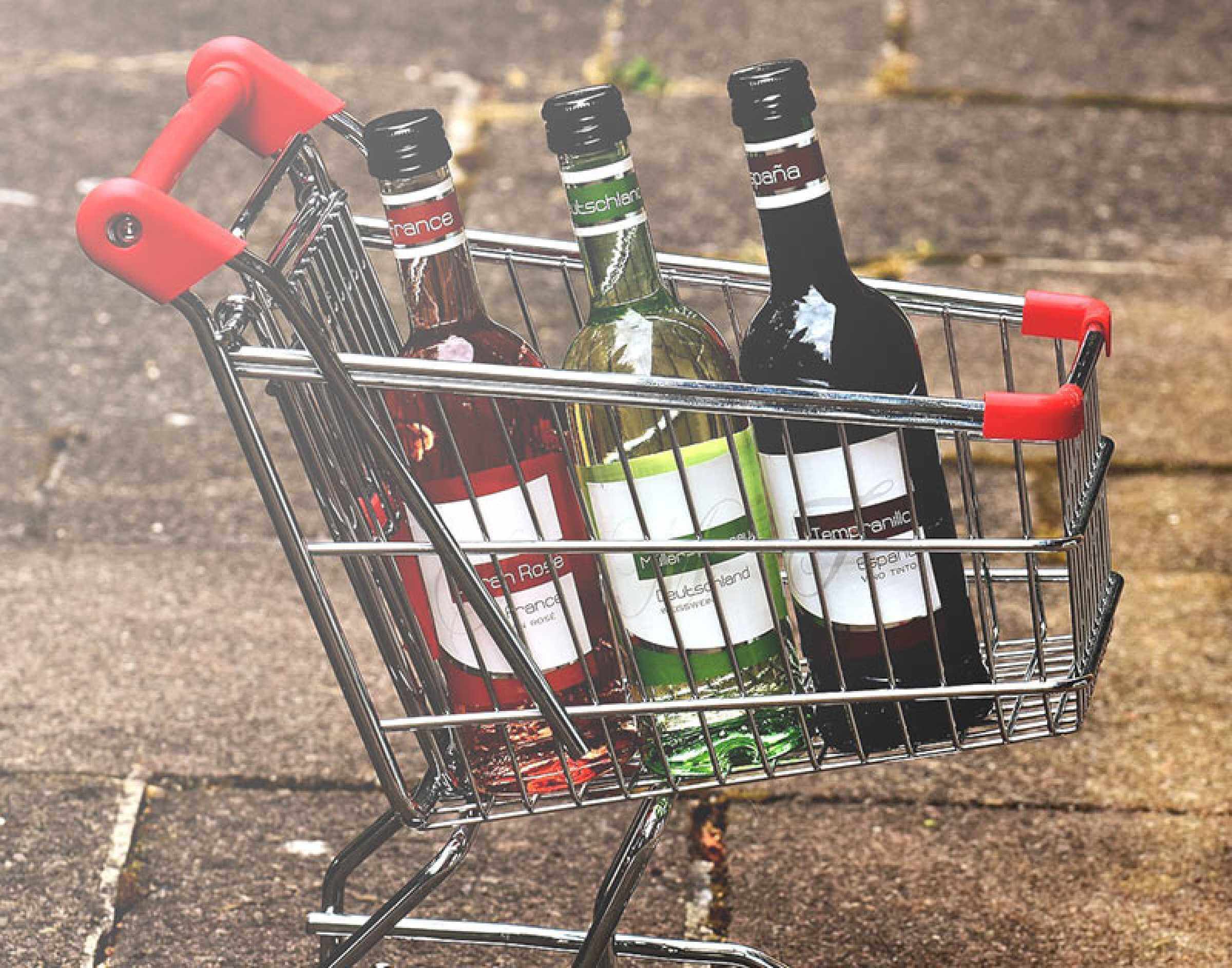 Shopping trolley filled with bottles of wine