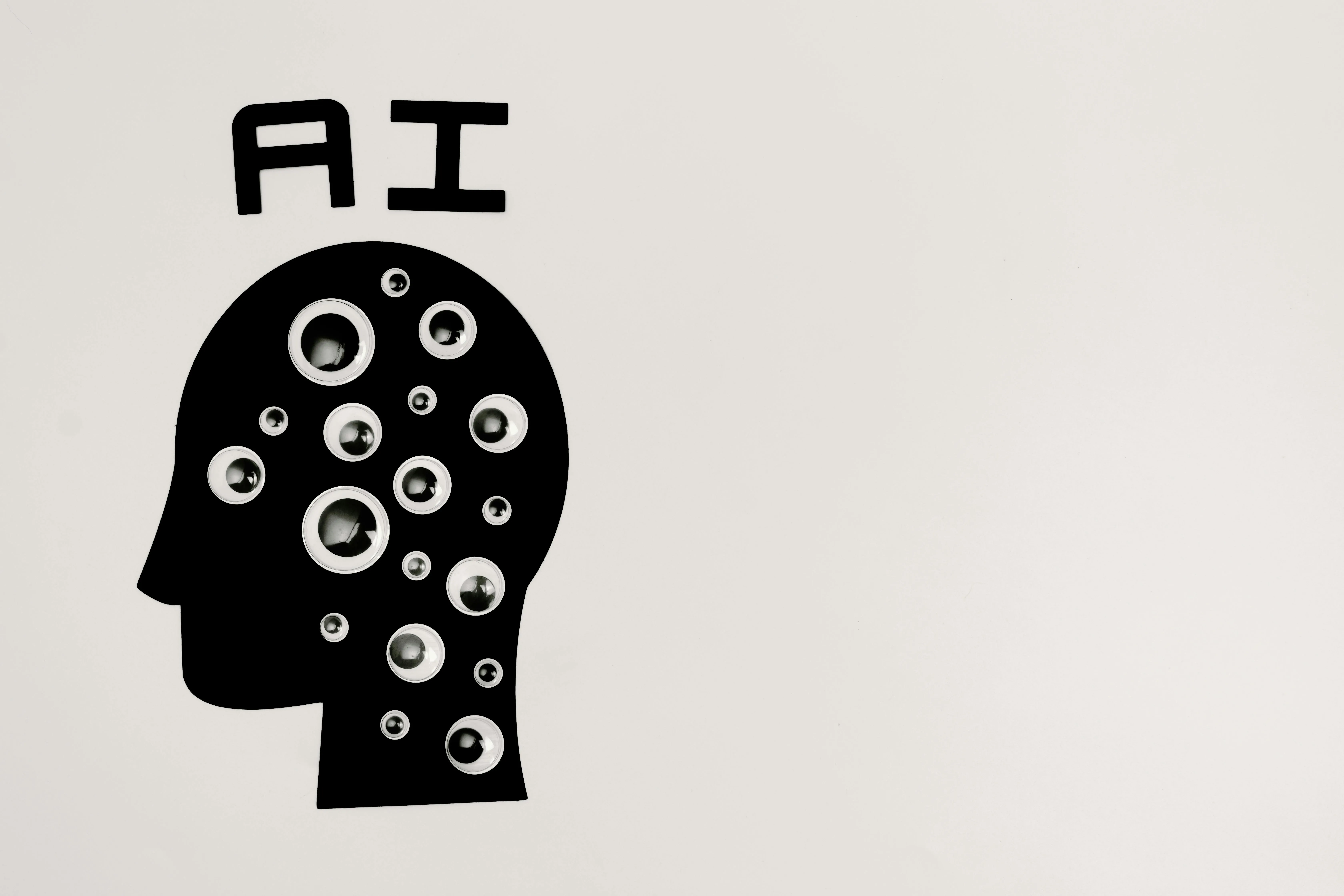 A head silhouette with eyes on it and ai written above it 