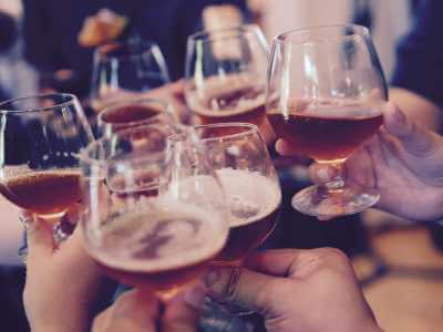 People toasting with glasses filled with beer